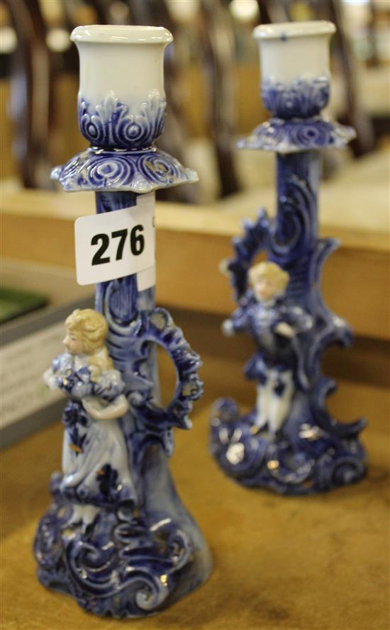 A pair of ceramic candlestick holders with male and female figurines, 20cm